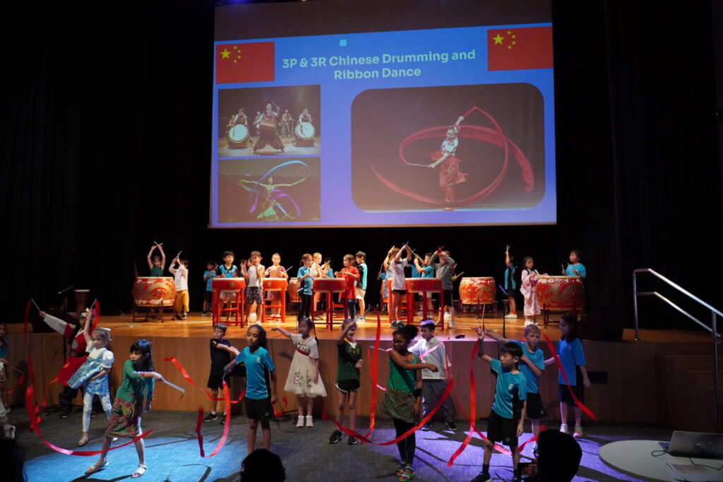 Children performing Chinese cultural dance at school assembly